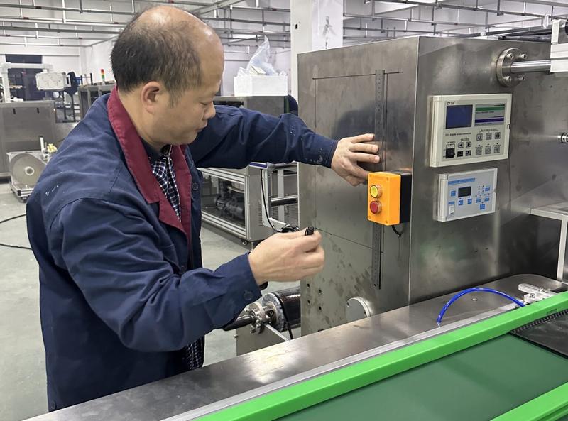LTC Pack engineer running a validation test on an HFFS flow-wrap machine in the test bay